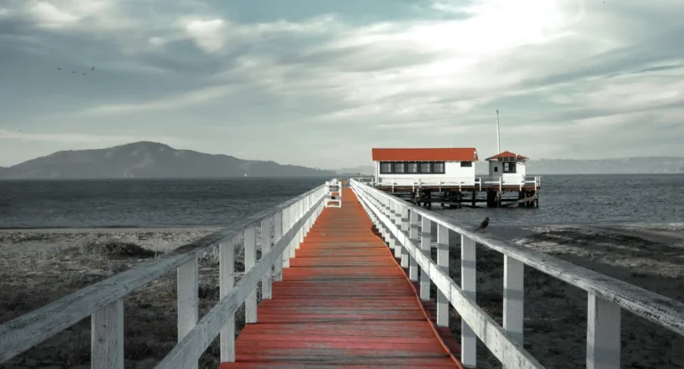 wide shot of a pier leading to a bay