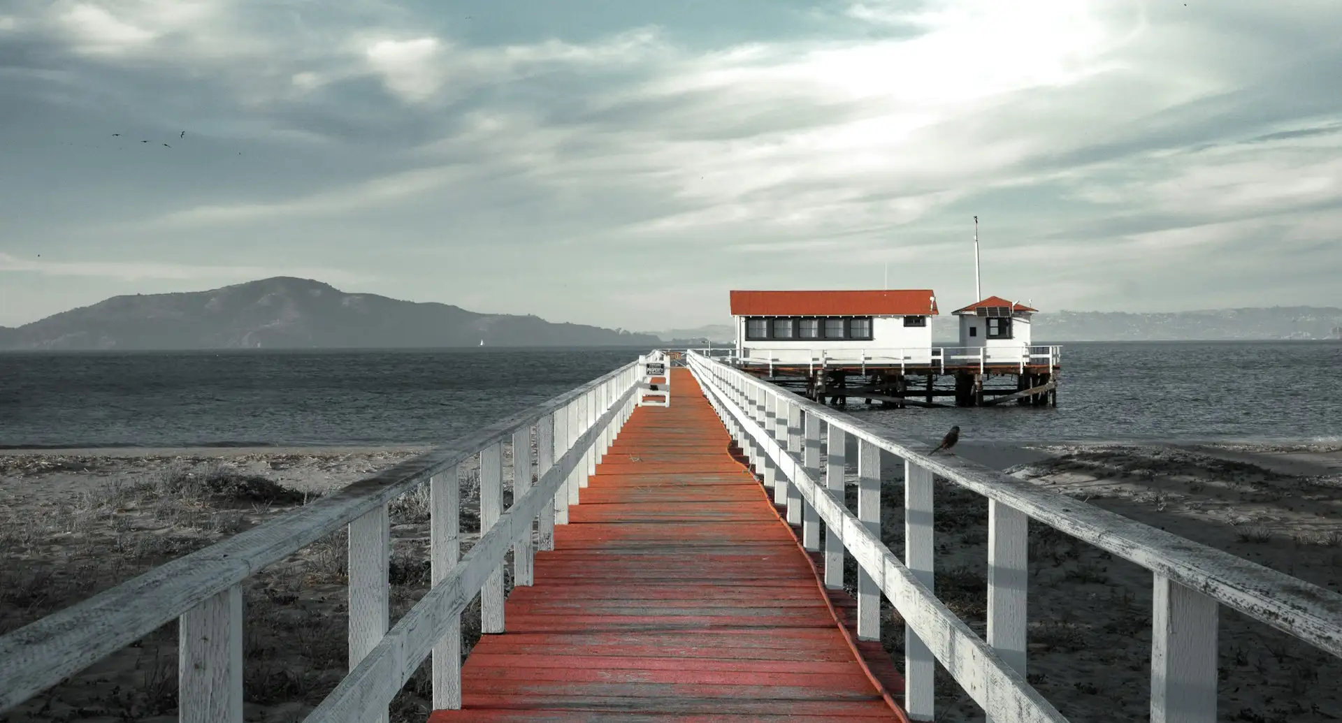 wide shot of a pier leading to a bay