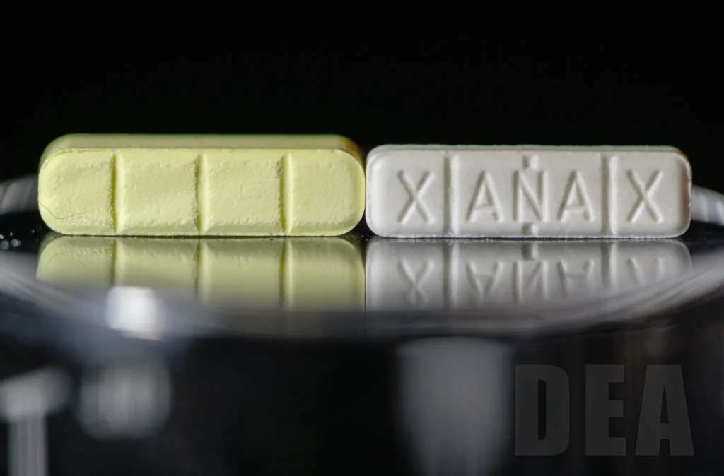 closeup of 2 pills side by side - comparison between counterfeit Xanax (left) and authentic (right).